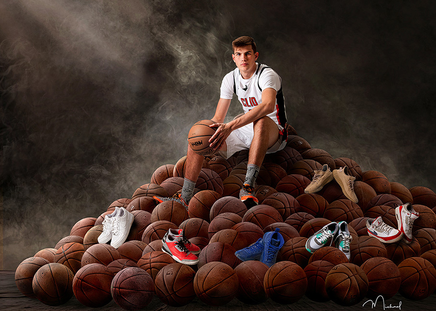 Senior boy on ball pile